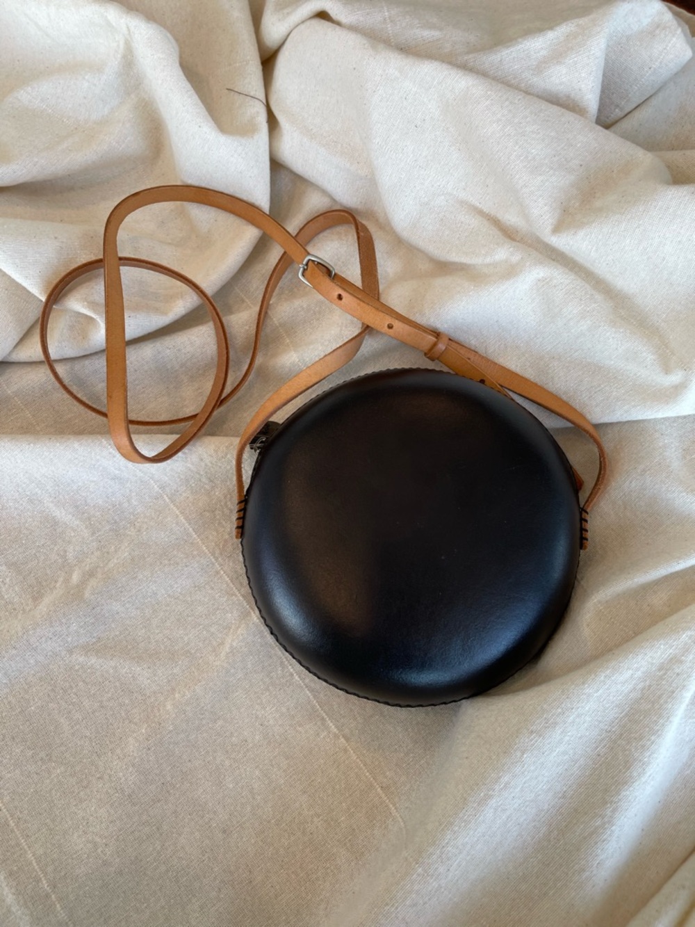 Minimalist Black Round Crossbody with Tan Strap